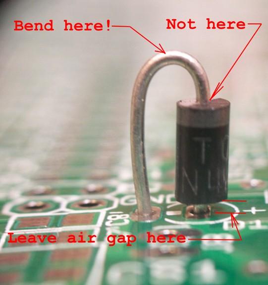 After finishing soldering the components with wire leads, cut the extended unwanted wire leads flush against the solder joints, that way no shorts can occur when they bend afterwords.