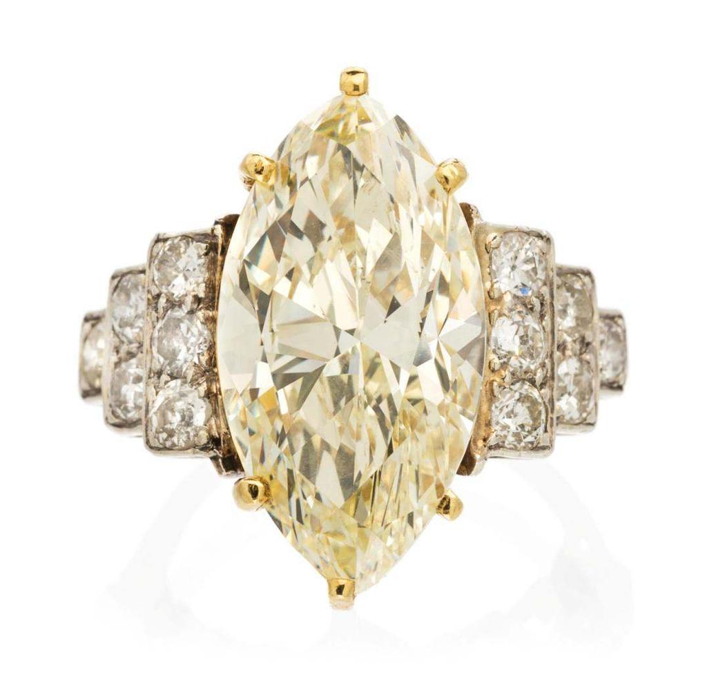 Sale 394 Lot 520 A Two Tone Gold, Colored Diamond and Diamond Ring, containing one marquise cut diamond weighing approximately 9.