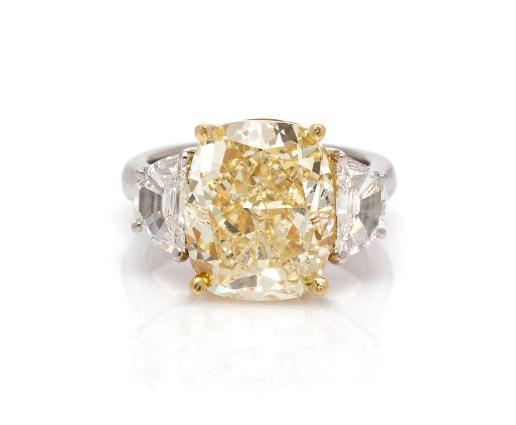 Sale 394 Lot 286 A Platinum, 18 Karat Yellow Gold, Colored Diamond and Diamond Ring, containing one cushion modified brilliant cut fancy light brownish yellow diamond weighing approximately 8.