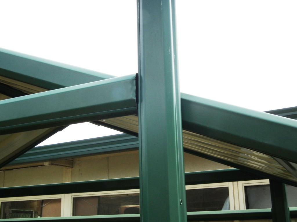 Vertical posts attach to A frame next to horizontal bracing. Photo shows two posts interlocked and screwed together for additional strength.