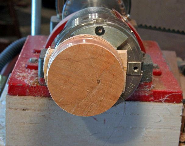 Once the dome is roughed to shape, switch to a skew or V-pointed tool and make a dimple at the center to guide a drill.