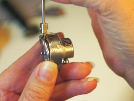 With your left hand, pull the needle Bar down while you rotate the Rotary Hook into position.
