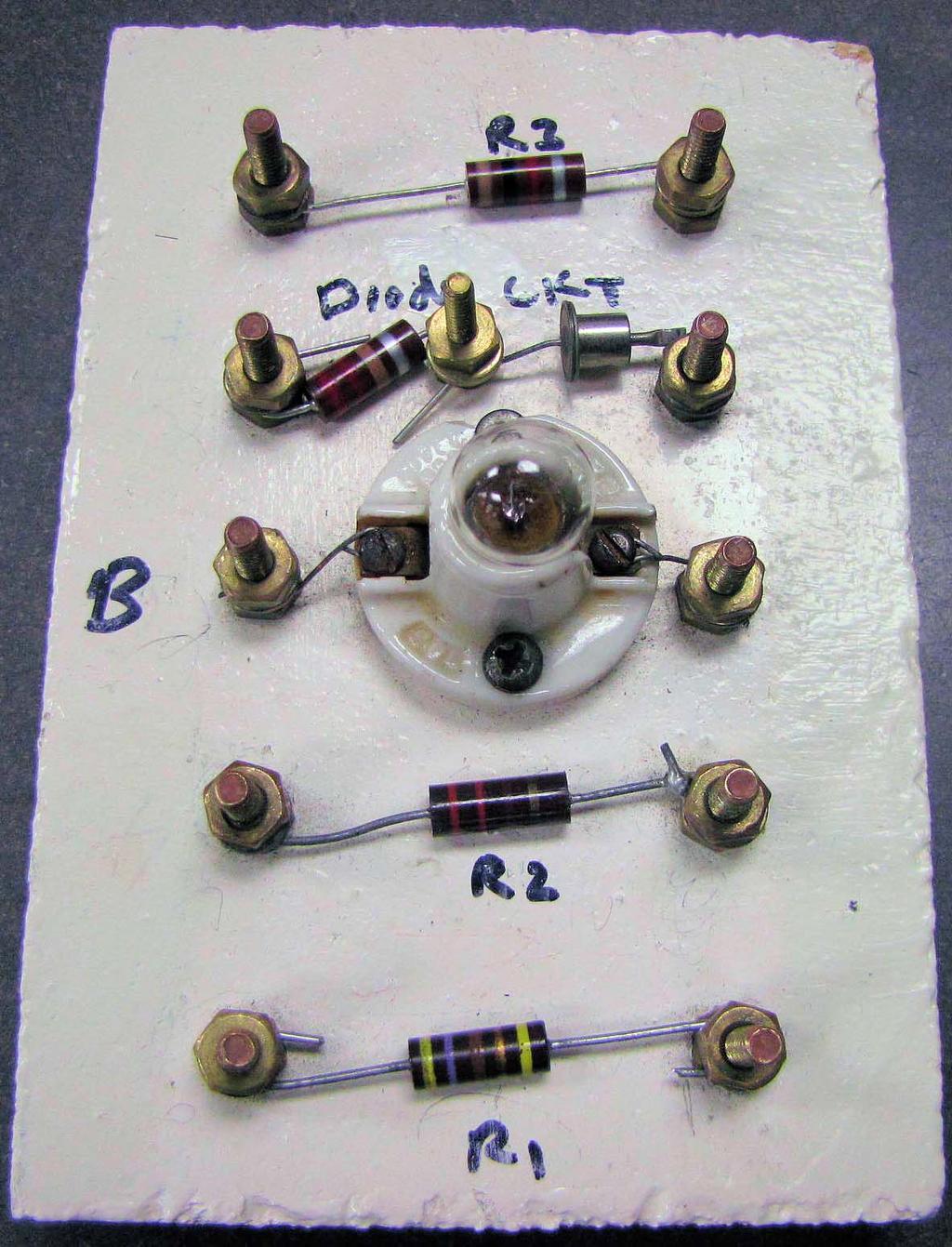 6 Figure 7 shows the board with 6 components on it: 4 color-coded resistors, one flashlight bulb (the one on your board may look a bit different from the one in the figure), and one silicon diode.