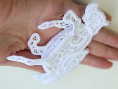 Make sure the right side of the lace is on the outside of the unicorn, and hand sew starting from under the snout to the