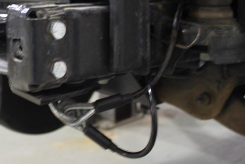 cables. Be sure the safety cables do not rub against any hoses or moving parts. Do this on BOTH sides of the vehicle. 14. Reinstall the metal bumper. Trim the belly pan as shown above, then reinstall.