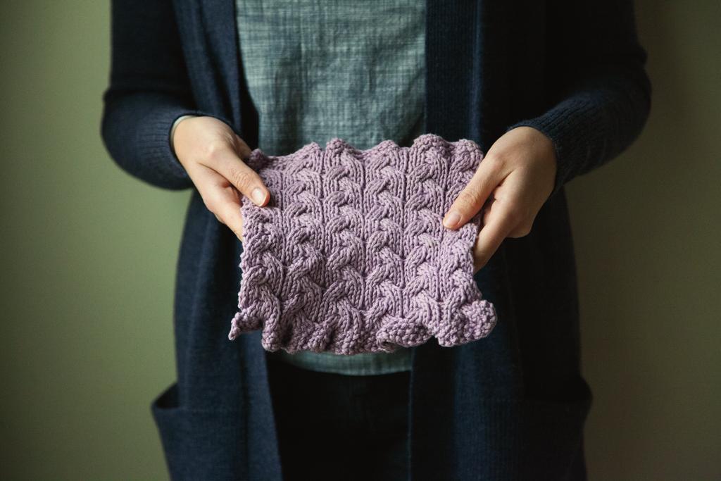 Washcloth Notes: Ruffles and cables make this reversible washcloth as pretty as it is practical.