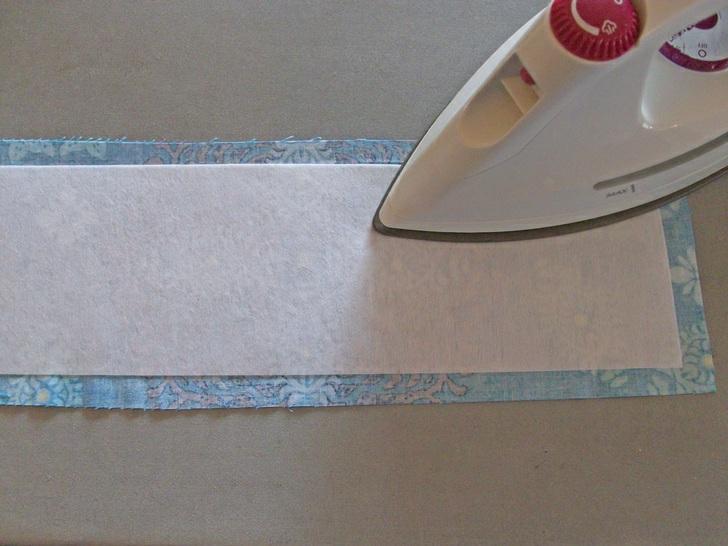 NOTE: The interfacing is cut 1" smaller than the fabric piece to keep it out of