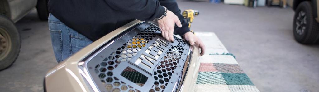 Gently insert each screw completely so that it bites into the plastic components, while simultaneously pulling the Inner Grille outwards to prevent any gaps between the Outer Trim and Inner Grille.