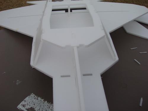 In order to allow the pieces to tilt inward, you may have to trim out the slots in the main body/wing of the model.
