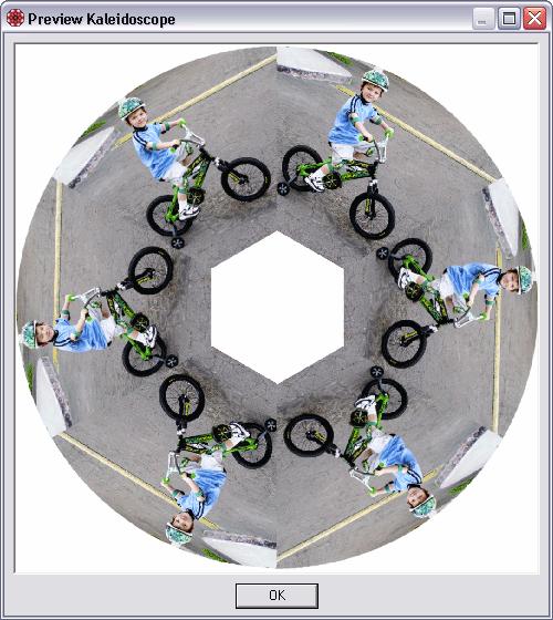 Kaleidoscope: Because of the mirroring effect of kaleidoscopes, it looks like the boy on the bicycle is