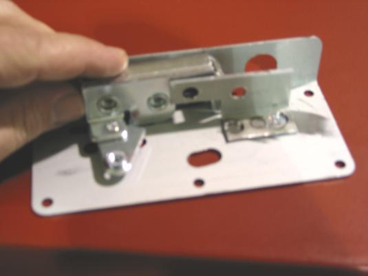 11. Bolt the rotary latch to the adapter panel by sliding the