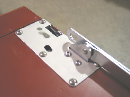 Slide the link assembly through the slot in the adapter panel and tailgate skin.