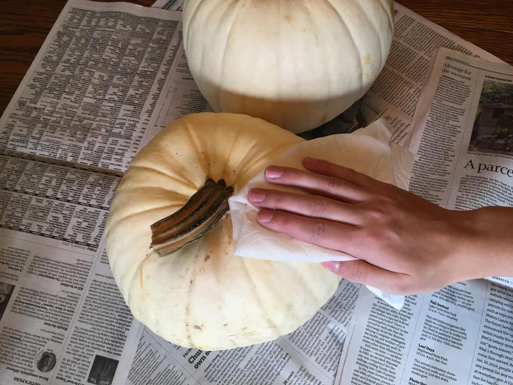 We started by cleaning surface of pumpkin with a paper towel soaked in warm water.