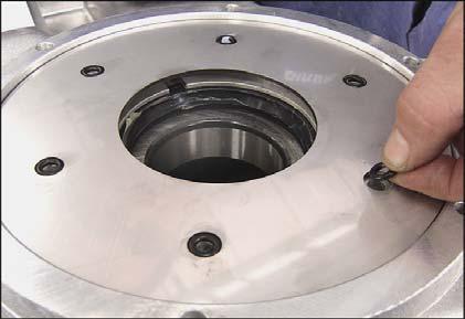 13 - Place the Vring protection plate in position and