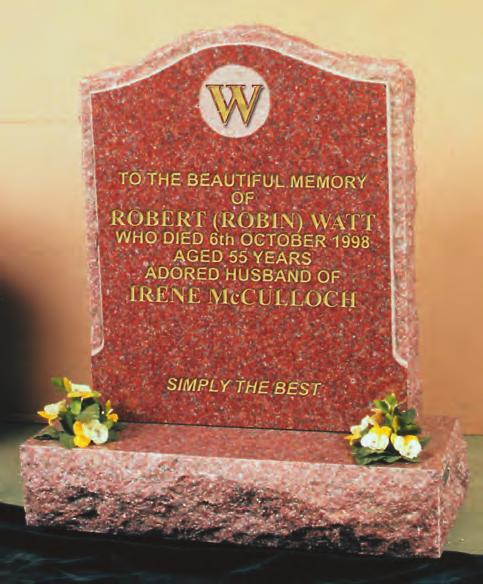 WATT Royal red granite memorial which includes a raised family initial within a deeply carved circle has