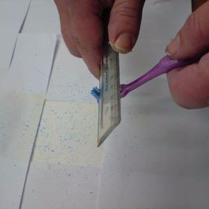 A stiff brush can also be used to produce a stippling effect. Again test the colour first on a scrap piece of paper.