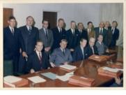 -- Digitized 2011. -- 1 photograph (jpeg) : col. Item is a photograph of John Geller and other lawyers posed around a boardroom table.