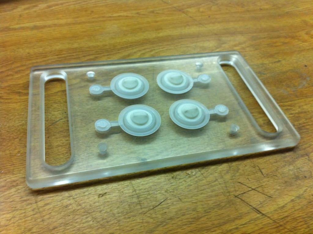 4 Insert the duckbills into the four part tray as shown in Figure 4. The duckbills should have the nipple facing up, and set into the outer ring of the flip cap.
