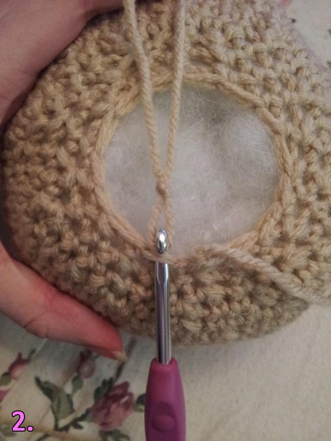 With really light brown yarn: You're going to pick up stitches around the opening of the head. Go through both loops, starting from the back / where you f/o'd the head piece.