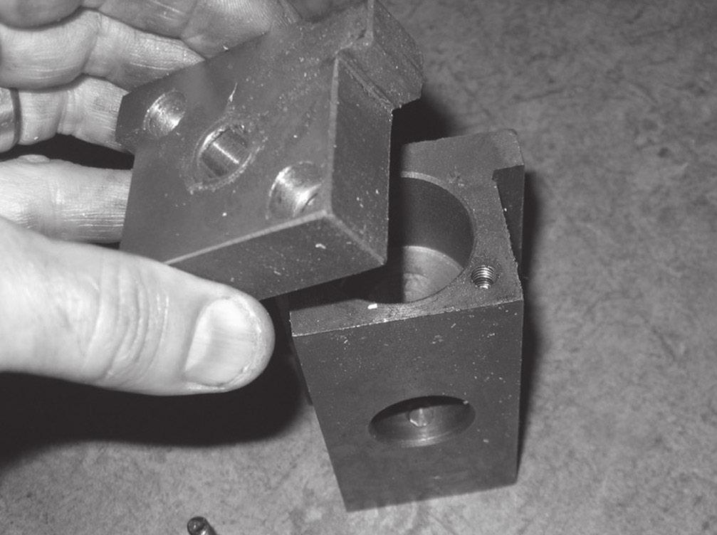 Lift out the slide block without losing the brass anti-score plug (Figure 8). Figure 9. Slide block end-cap removal. 11.