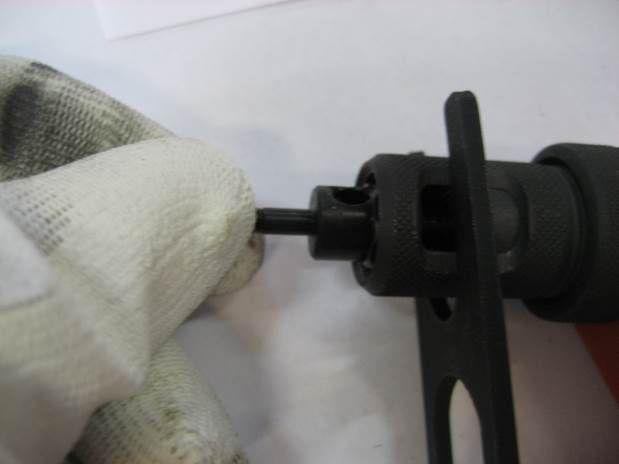 With the tool supplied pull the casing of the threaded rod back and unscrew the screw the rod manually until it can be