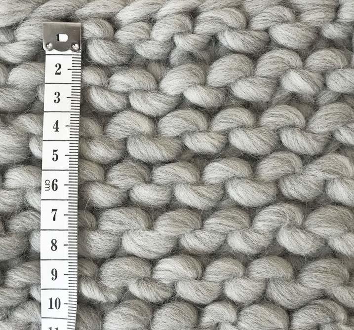 HOW TO MEASURE YOUR TENSION SWATCH Lay your swatch flat without stretching it out. Measuring rows in garter stitch Place your measuring tape on top of the swatch, a little way in from the edge.