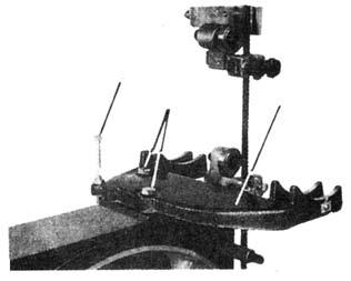 To install, thread a nut onto the bolt and turn the bolt into the threaded hole in the left, rear of the trunnion bracket. FIGURE 5 2.