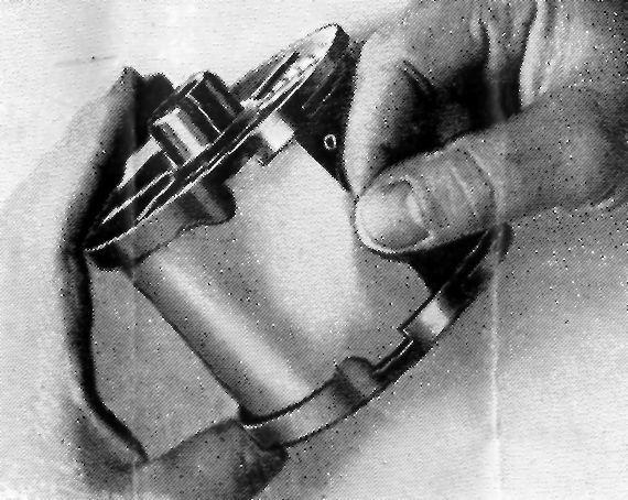 Before inserting the film into the groove, the leading end of the film should be straightened out by bending the edge backwards several times with finger and thumb.