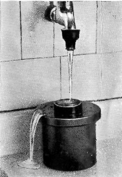 WASHING THE FILM. The film must now be thoroughly washed by placing the tank under a tap and allowing the water to run into the hole in centre of lid. See Fig. 7.