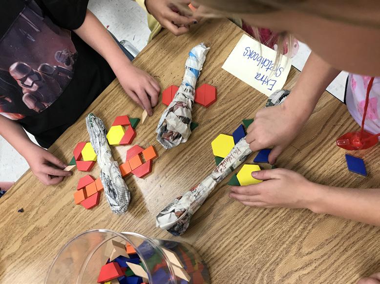 Give each student a large piece of newspaper and a few long strips of masking tape. Students will squish the newspaper into a long oval shape and wrap loosely with masking tape.