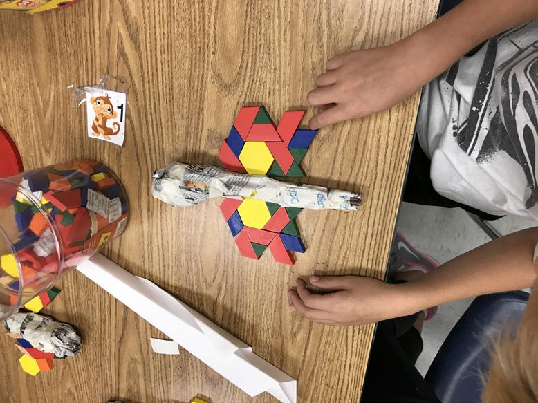 Remind students that insect wings are symmetrical, and that helps them to fly. Using their newly created insect bodies, students will build wings out of colored blocks or colored paper shapes.