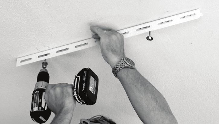 ) If the garage ceiling is finished with drywall, use a stud finder and locate the ceiling joists that are in the area of the installation.