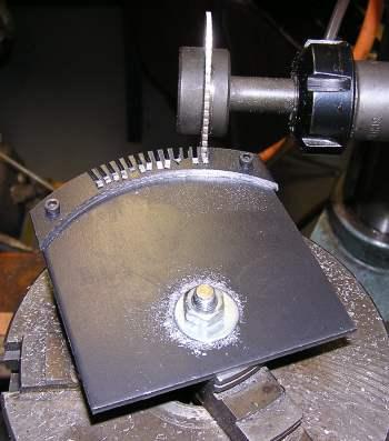 The rotary table was then mounted on the lathe/mill table and a 1/16" wide slitting saw mounted in the milling head. The plan was to use a 2.5 degree pitch and cut the teeth 0.70" deep.