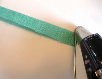 Assembling the Thread Catcher 1. Begin with the contrasting trim strip. Fold it in half lengthwise and press. 2.