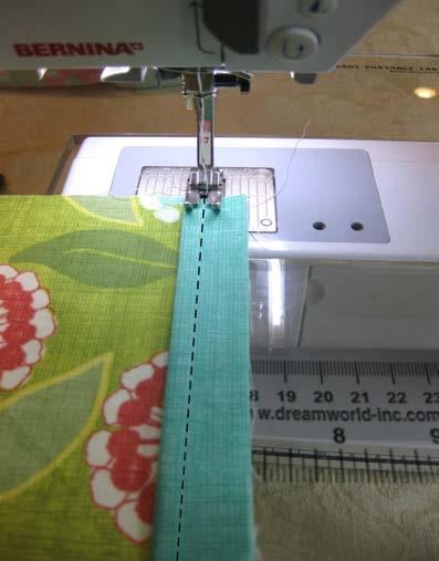 Place the trim strip on top of the outer bag fabric and interfacing, matching the raw edges of the trim strip with the raw edges of the outer bag and