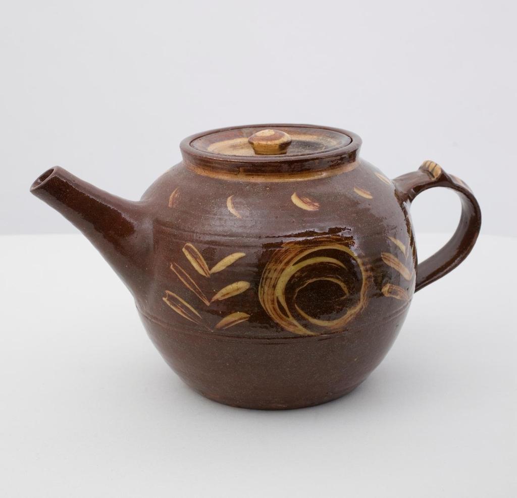 Earthenware Teapot 1926-42 Brown glaze with yellow painted decoration, ovoid body, tapering rim, cone