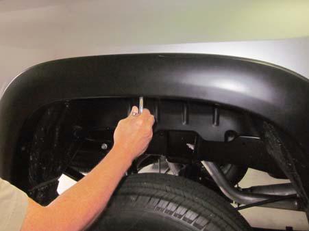 Remove push retainer from underside of factory mud guard. (Fig. 14) 3. Hold the flare firmly on the fender.