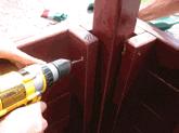 Secure sidewalls with four 3" deck screws through the bottom plates into 2x6's of the