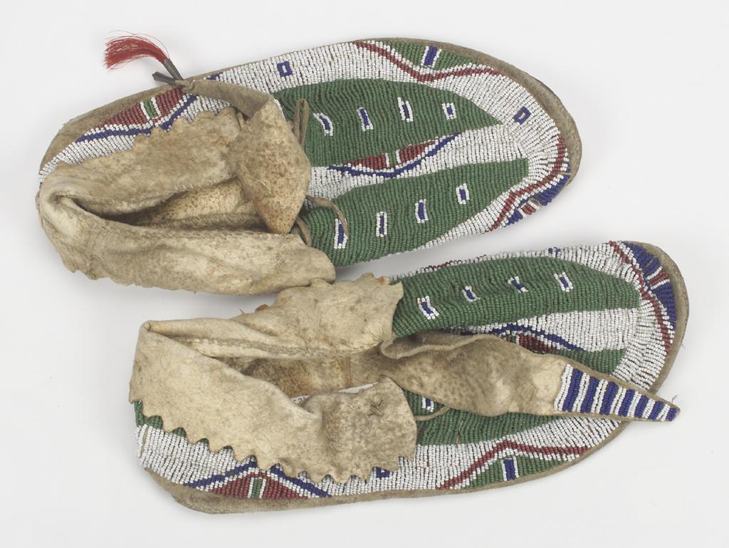 Compare the moccasins in the painting with those from NMAI s collection.