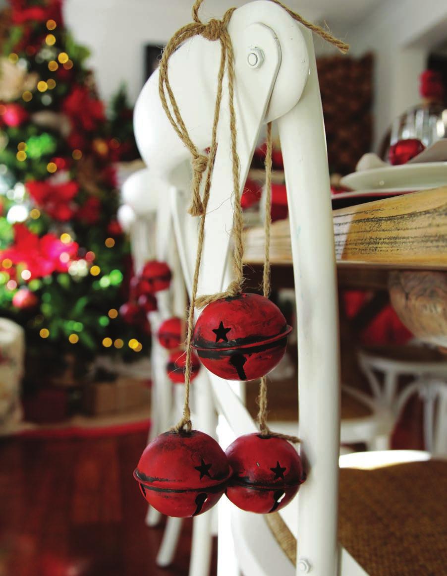 Decorating Tip HANGING ORNAMENTS OVER THE BACK OF CHAIRS ADD AN EXTRA LAYER TO YOUR CHRISTMAS TABLE.