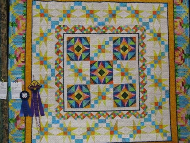 Tropical Encounter was pieced by Connie Tiefel and Quilted by Pam