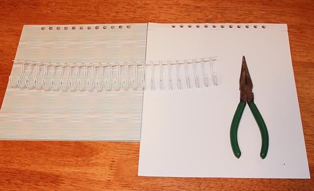 With the inside cover folded, place it over the scrapbook pages matching up the holes.
