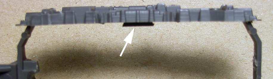 The following photo shows the unnecessary parts removed from the frame. However, there are two wedge shaped sections that must be shaved off the side frames, as indicated by the white arrows.