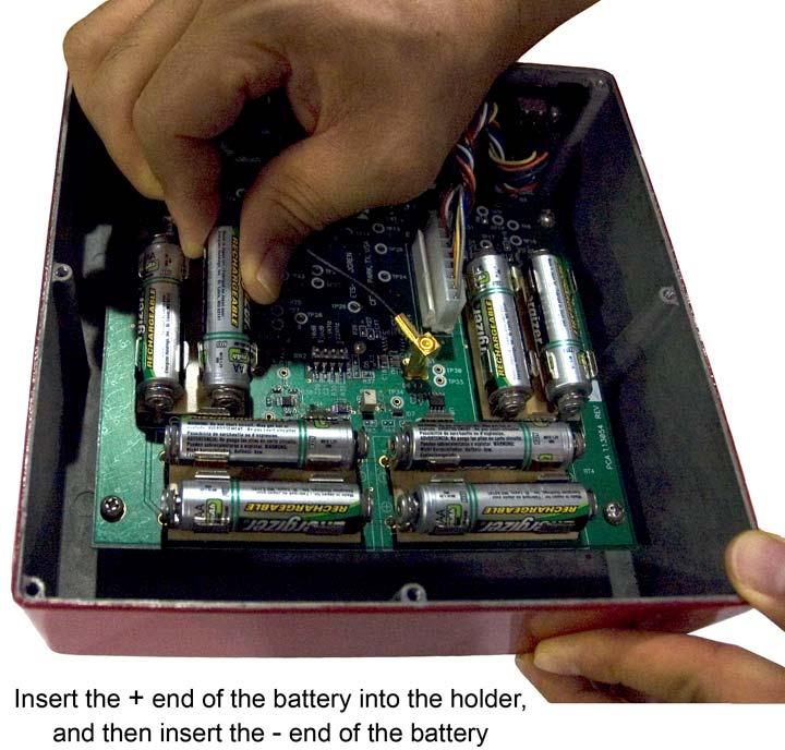 7. Insert one new battery into each battery holder, matching the /+ on the battery with the /+ on the board.