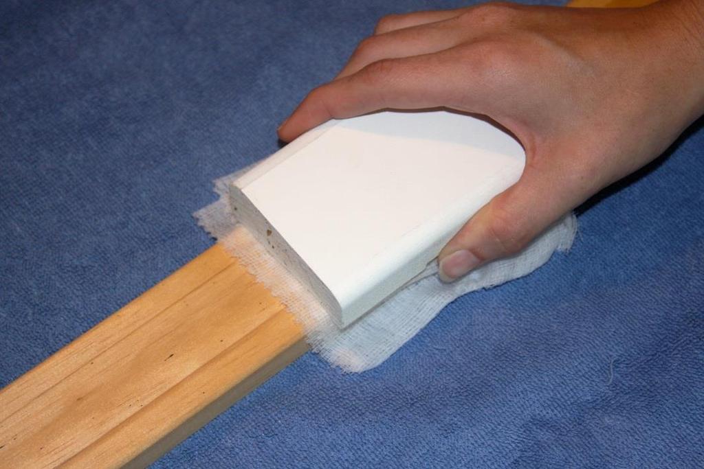 Cleaning the Surface After sanding the trim, wipe it down with a cloth. Next remove the sanding strips from the Trim Sander and replace with the tack cloth. Simply rub across the molding.
