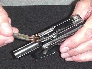The CLOSED coil of the spring goes on first - facing to the rear of the gun.