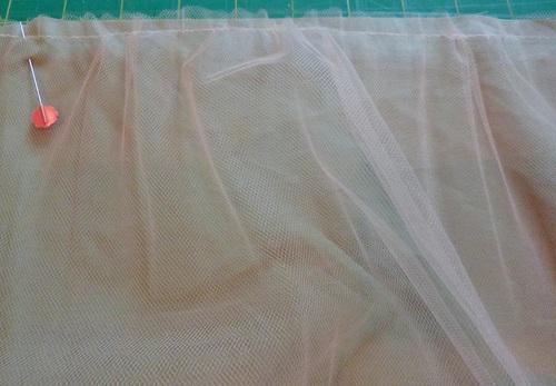 Pull the gathering stitch gently until the tulle is the same width as the bottom (Sage) tier (44"). 5.
