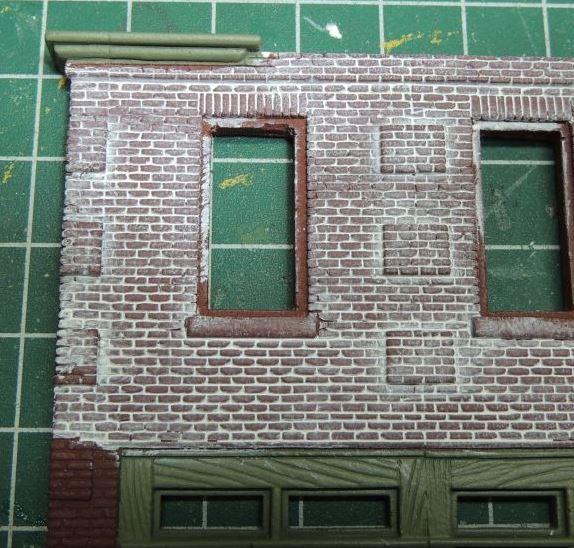 We then masked the storefront, and painted the brick with a Rust-Oleum brown primer.