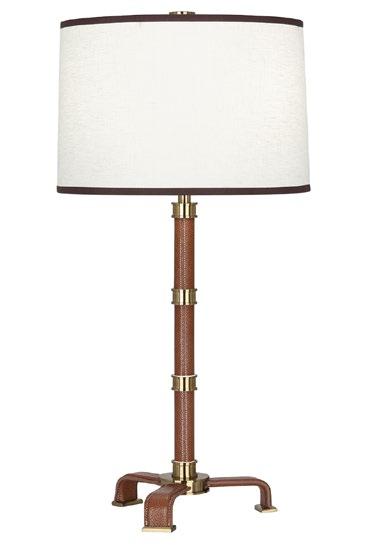 Saddle/ brass Saddle/ brass VOLTAIRE TABLE LAMP Pebbled leather with chunky metal cuffs topped by a linen shade with fabric trim Available in saddle leather with polished brass or black leather with