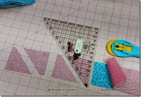 Cutting pinks/aquas into 280 triangle pairs! I am using the Easy Angle Ruler for the half square triangles in this quilt.